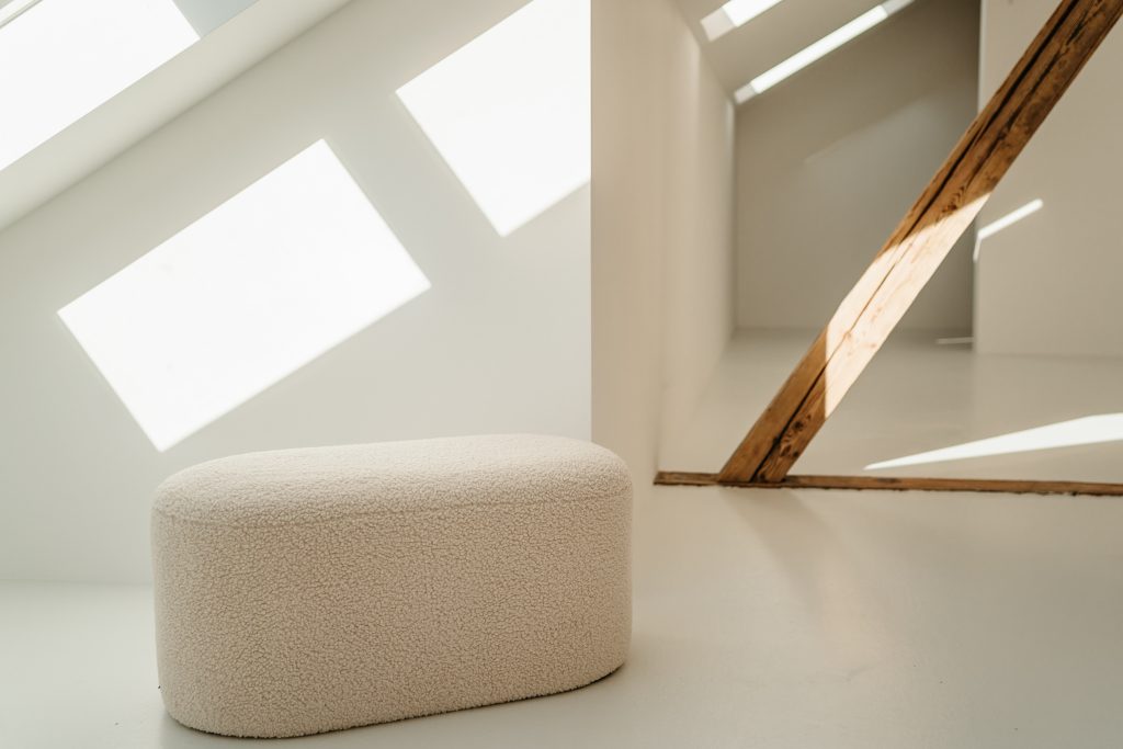 Foto von einem Holzbalken im studio liz. Vor dem Balken steht ein Hocker.